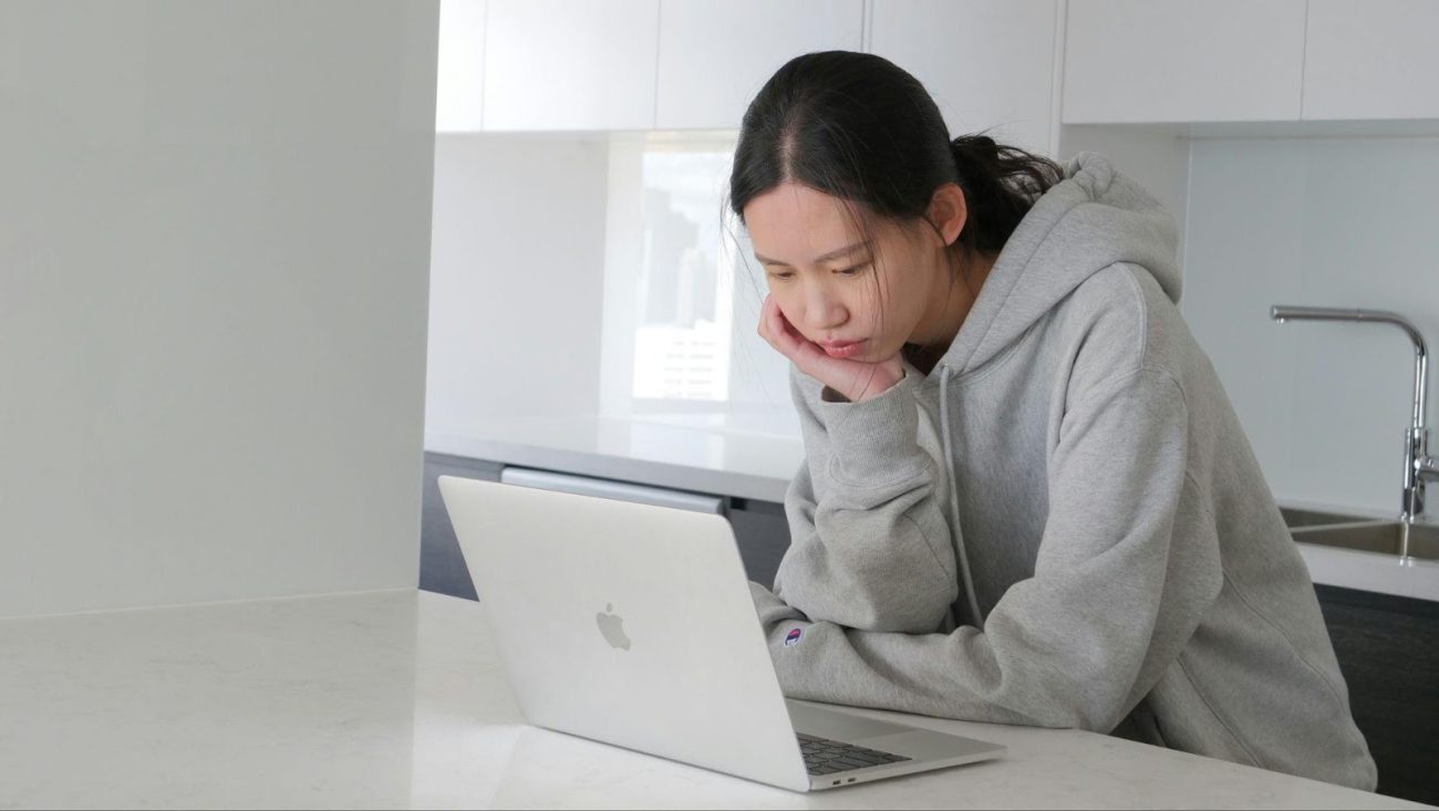 Woman reviewing medical paperwork at home after a slip-and-fall accident as a part of personal injury lawyer consultation preparation.